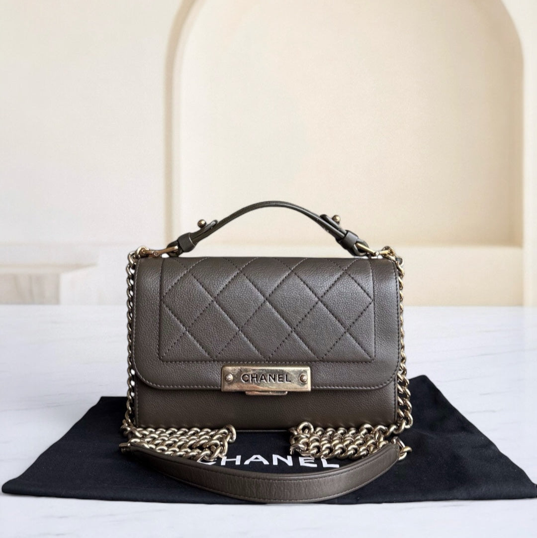 Chanel handbag with gold chain on a black and white background