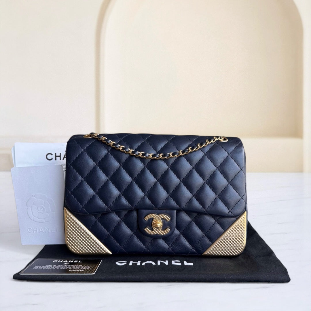 Chanel handbag with gold accents on a branded mat with a neutral background