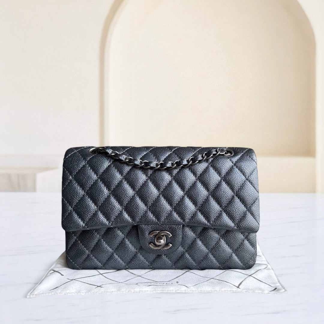 Quilted handbag on a white surface with a neutral background