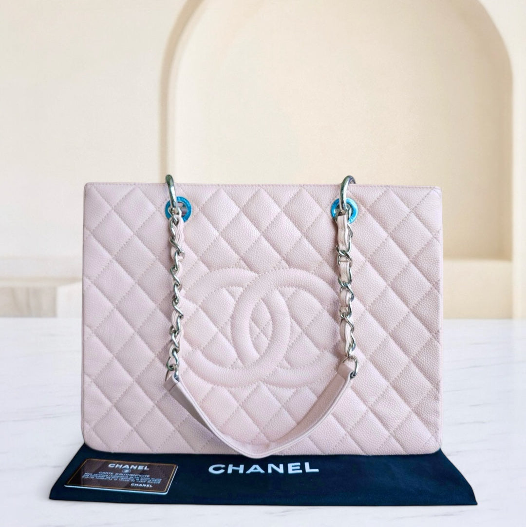 Chanel quilted handbag on a stand with a white background