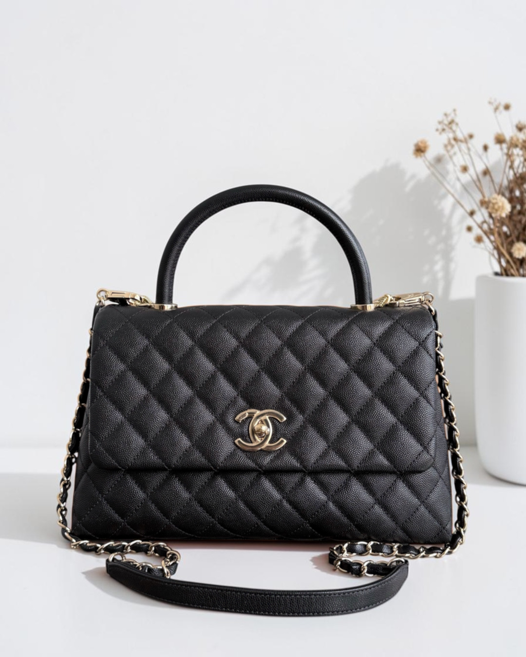 Luxury Evermore black quilted caviar leather handbag with gold hardware and chain strap