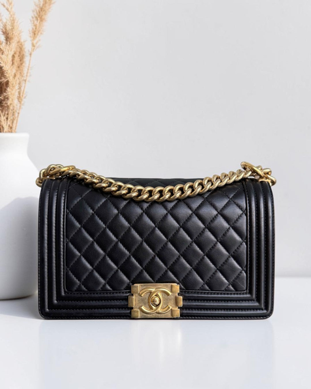Luxury Evermore Chanel Boy medium quilted black lambskin handbag with gold hardware and chain strap