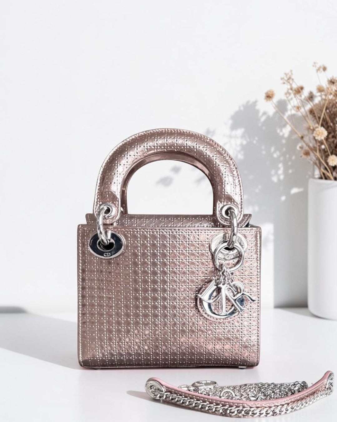 Luxury Evermore Dior Lady Mini bag in metallic rose gold calfskin with micro-cannage pattern and silver hardware.