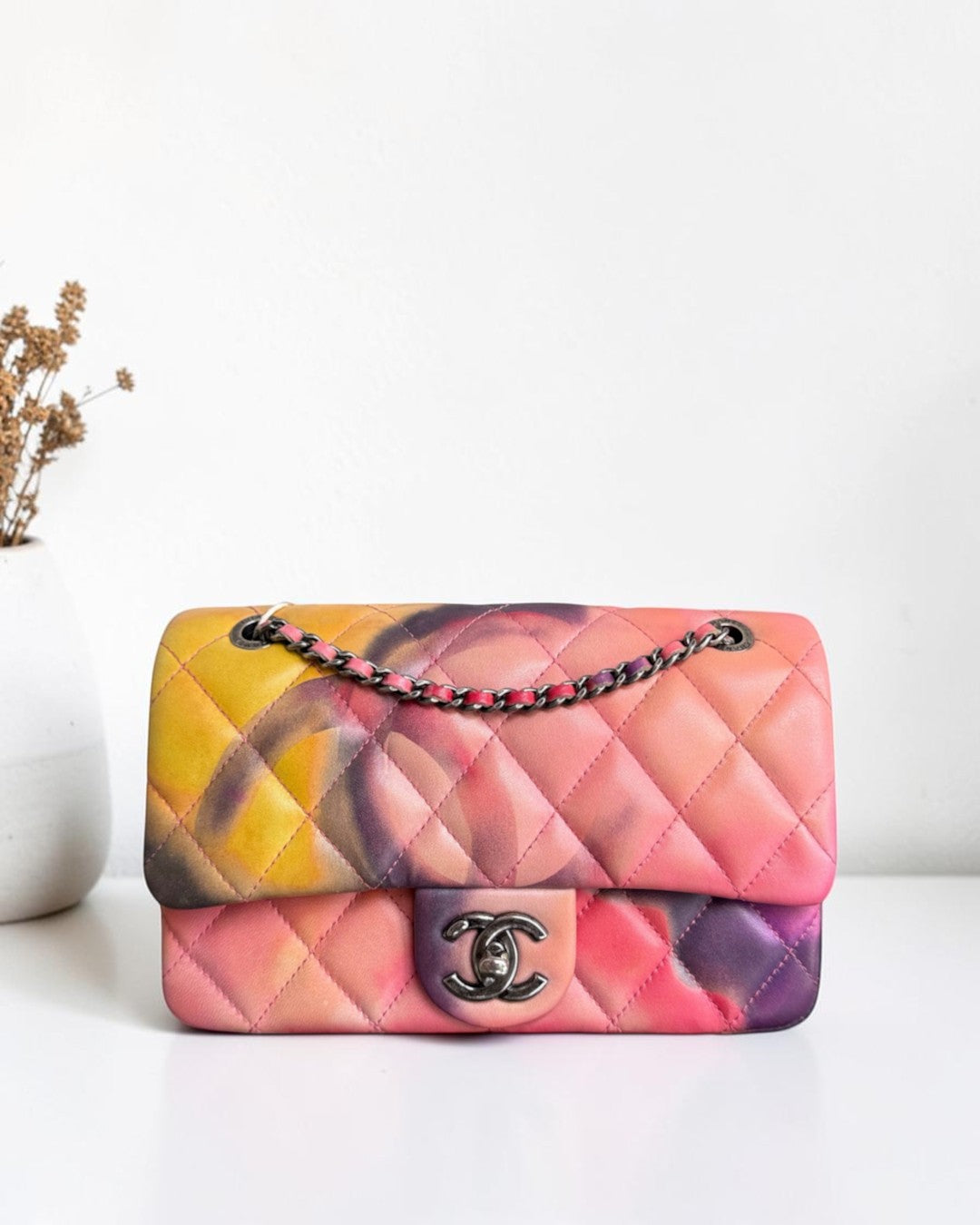 Luxury Evermore 21 quilted leather flap bag featuring a vibrant multi-colored floral print and dark metal hardware.