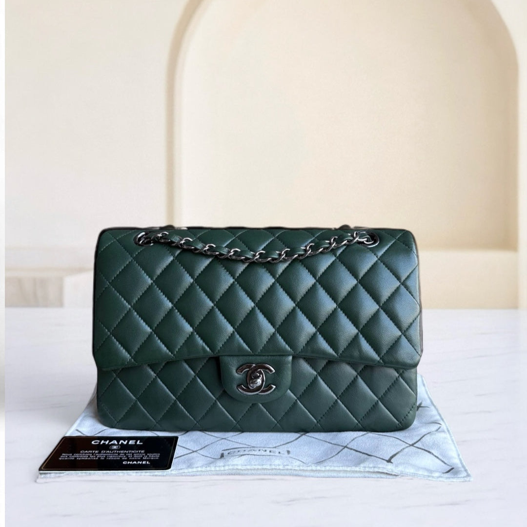 Green quilted handbag with Chanel logo on a white surface