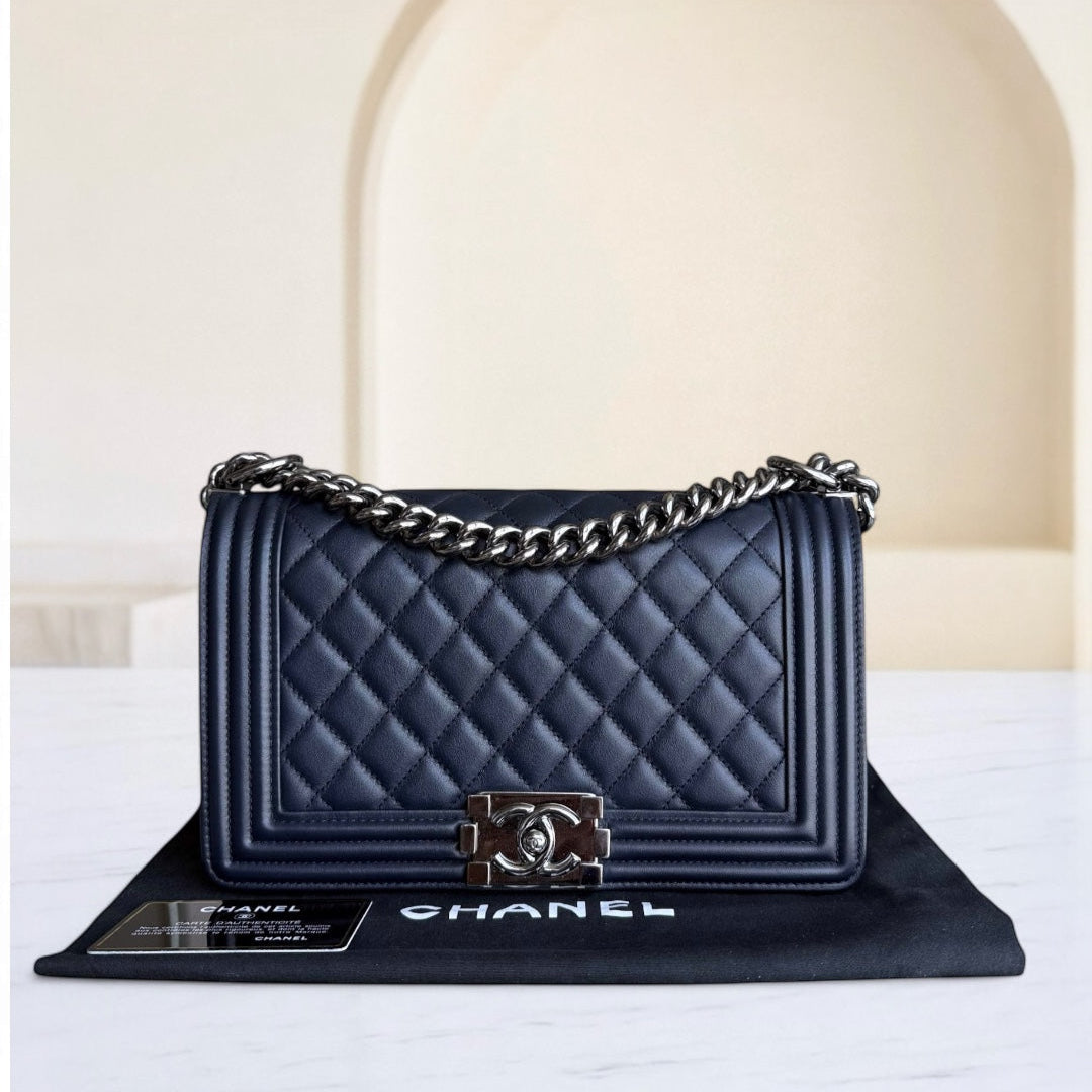 Chanel handbag with chain detail on a white surface