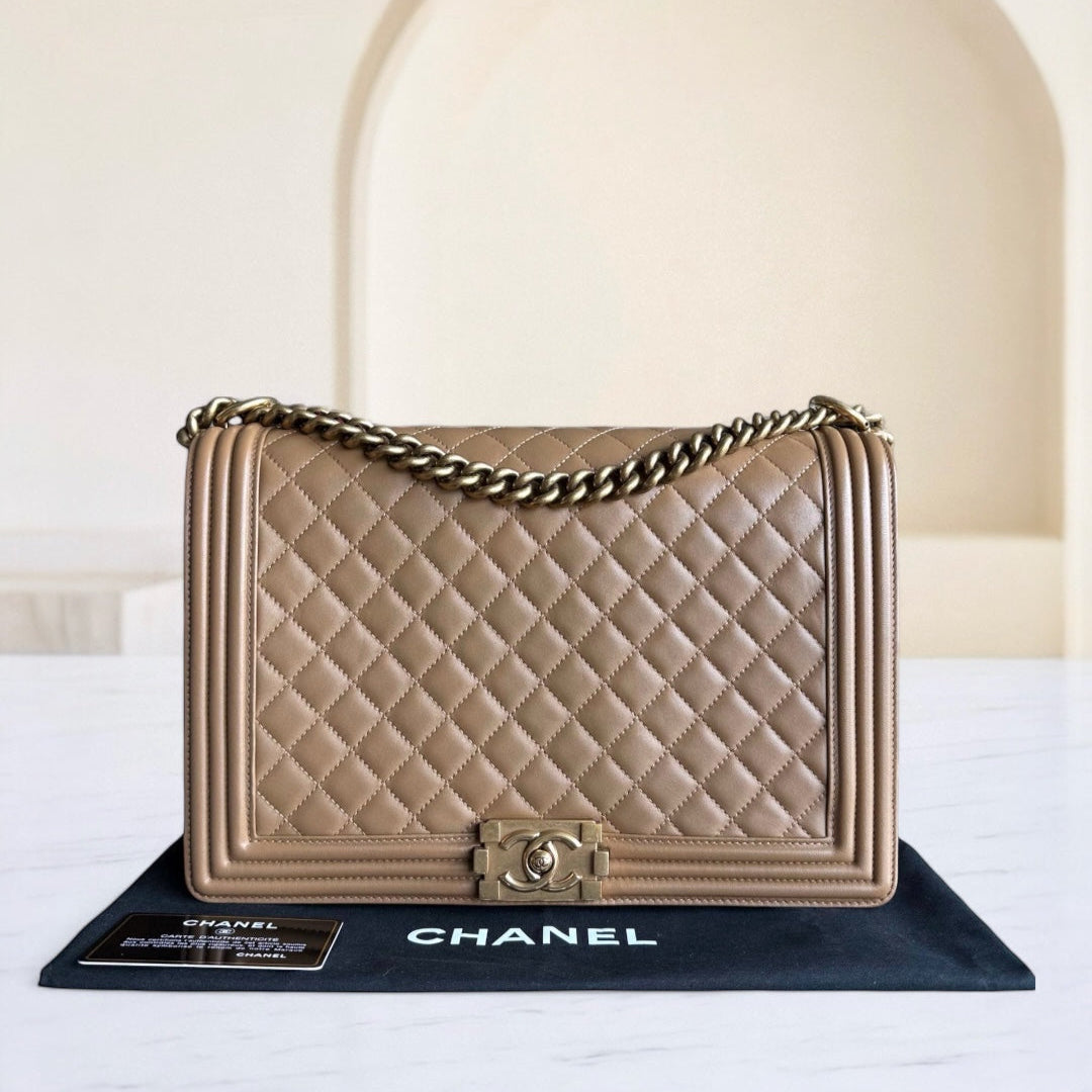 Chanel handbag with quilted design on a stand against a neutral background
