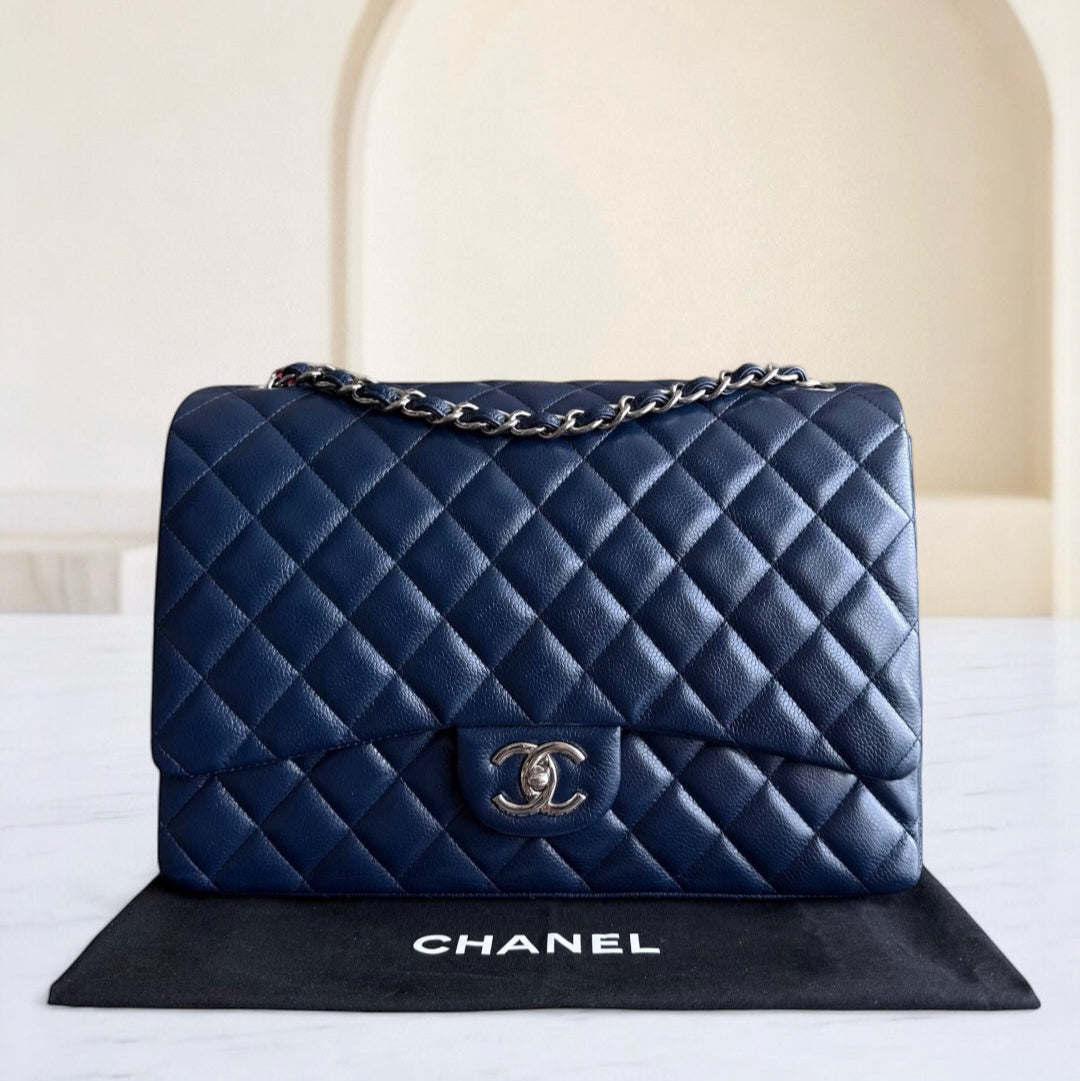 Blue quilted Chanel handbag on a white surface with a beige background