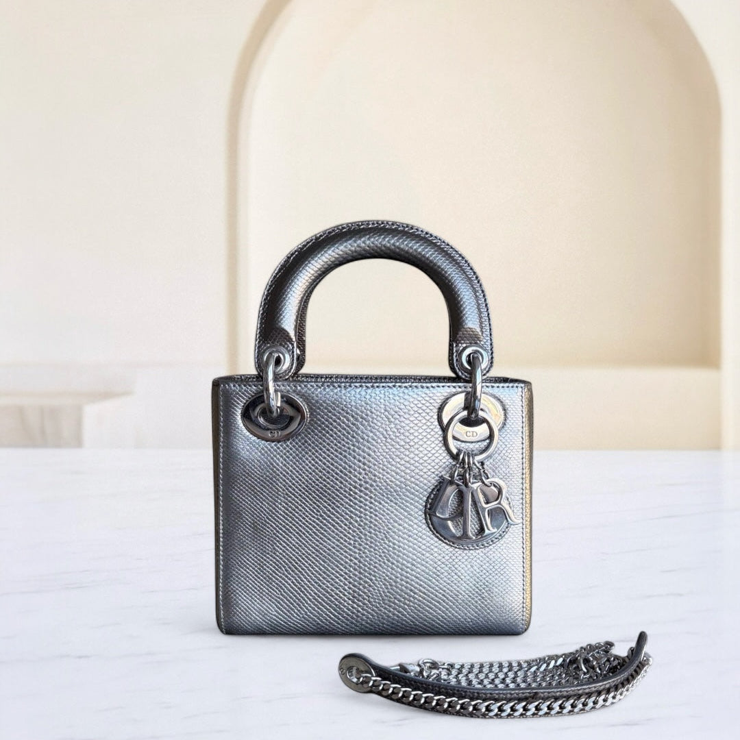 Silver handbag with chain detail on a white surface