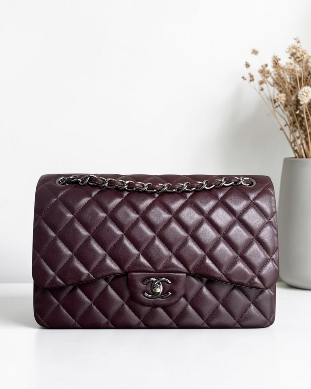 Luxury Evermore quilted burgundy leather handbag with silver chain strap and signature CC turn-lock closure