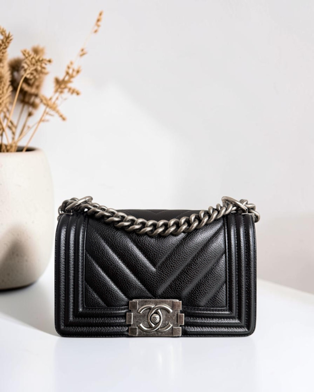 Luxury Evermore black quilted leather Boy bag with chevron pattern and silver-tone chain strap and CC clasp
