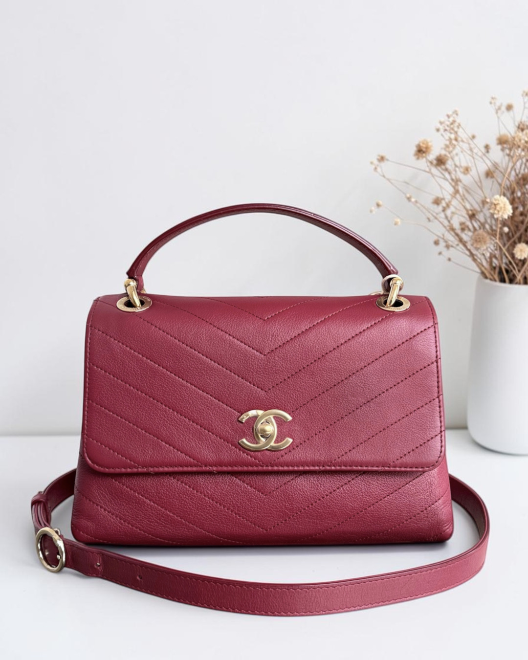 Luxury Evermore burgundy chevron quilted leather handbag with gold-tone CC logo hardware and top handle