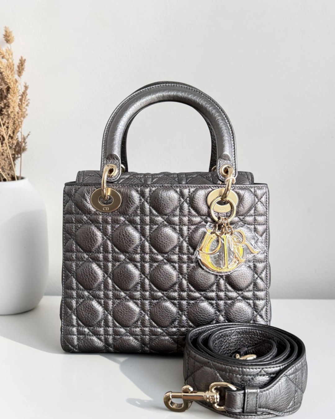 Luxury Evermore medium metallic silver Lady Dior handbag with cannage stitching and gold-tone hardware charms.