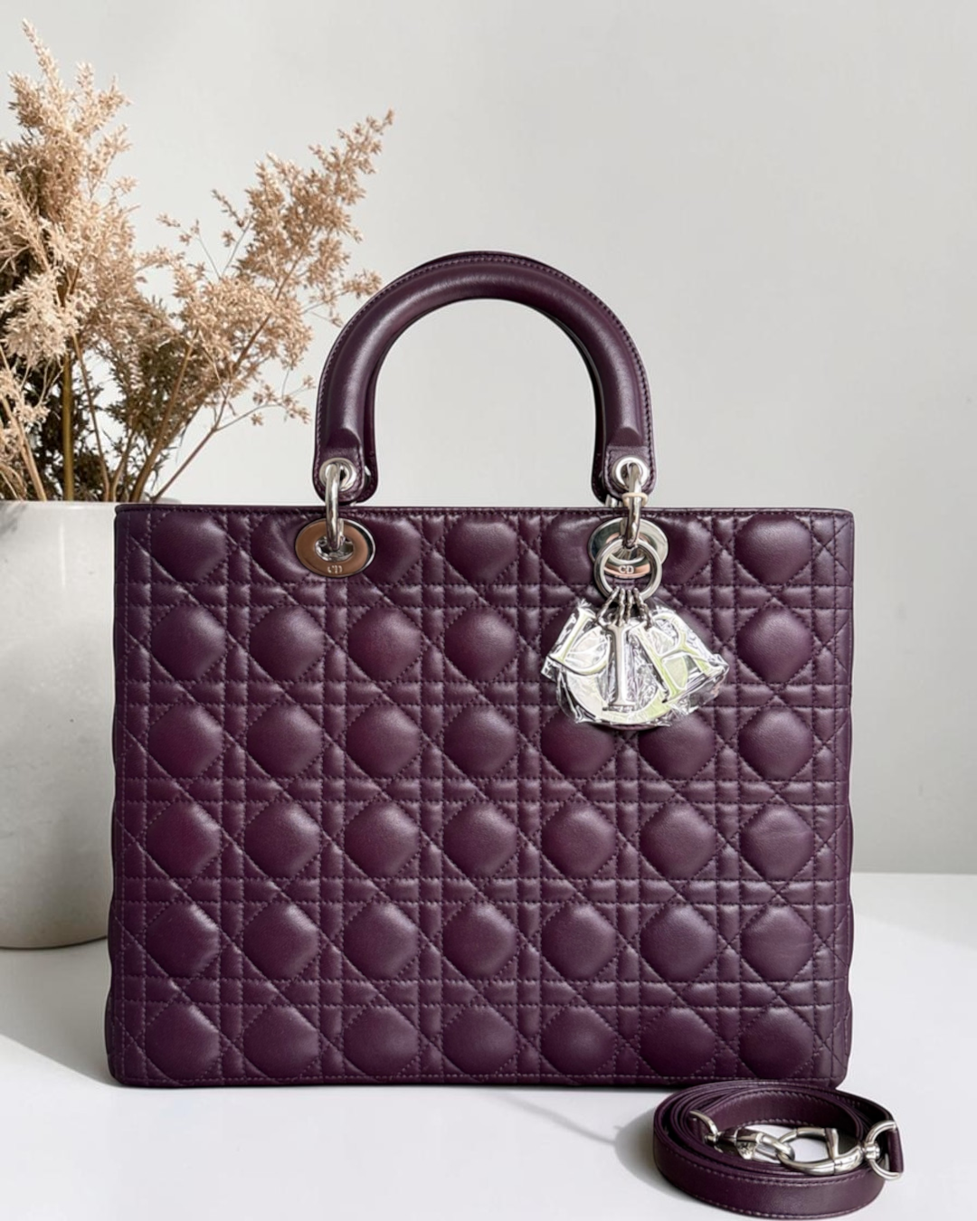 Luxury Evermore large deep purple quilted leather handbag with silver hardware charms and a detachable shoulder strap