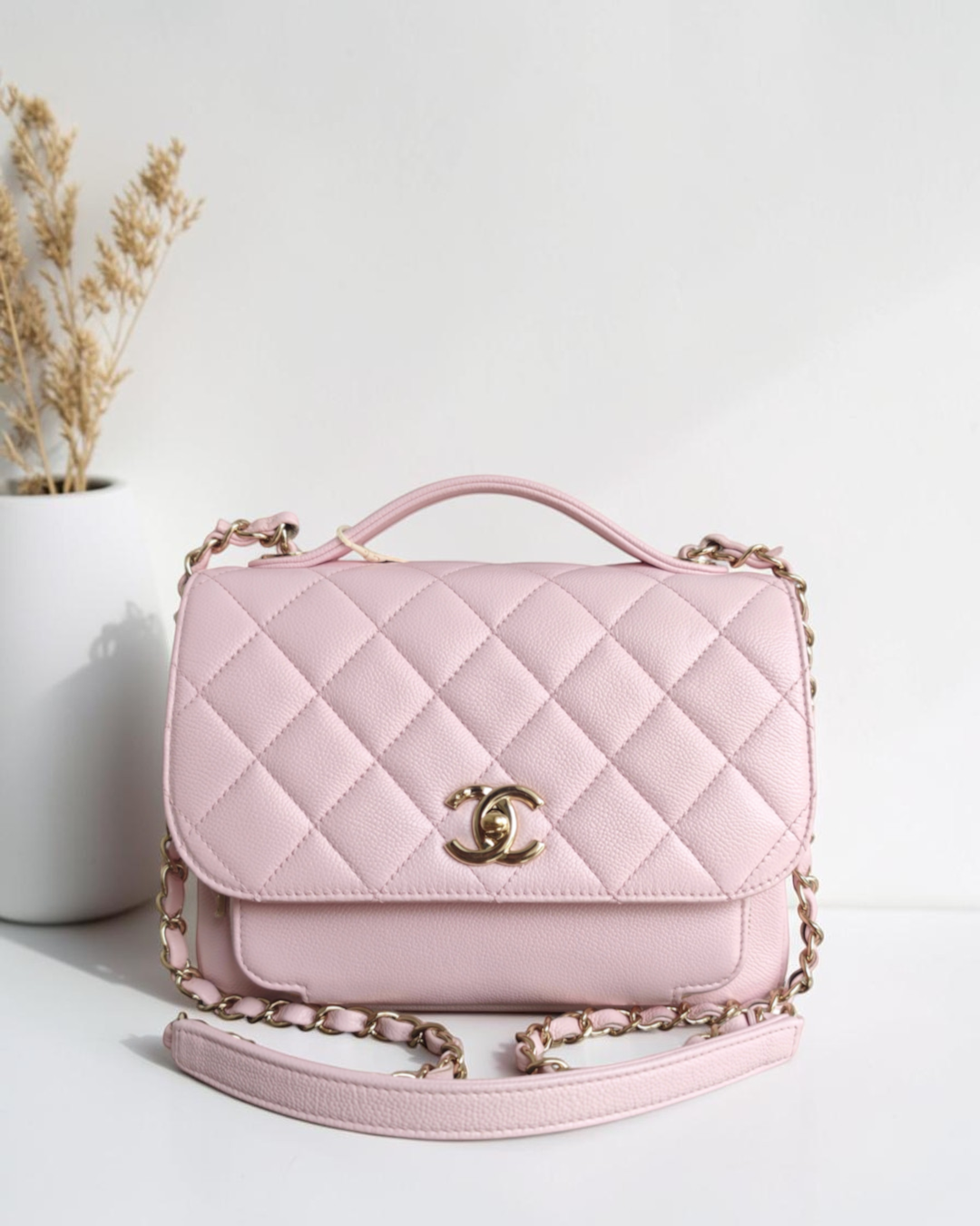 Luxury Evermore Chanel Business Affinity medium bag in quilted sakura light pink caviar leather with gold hardware.