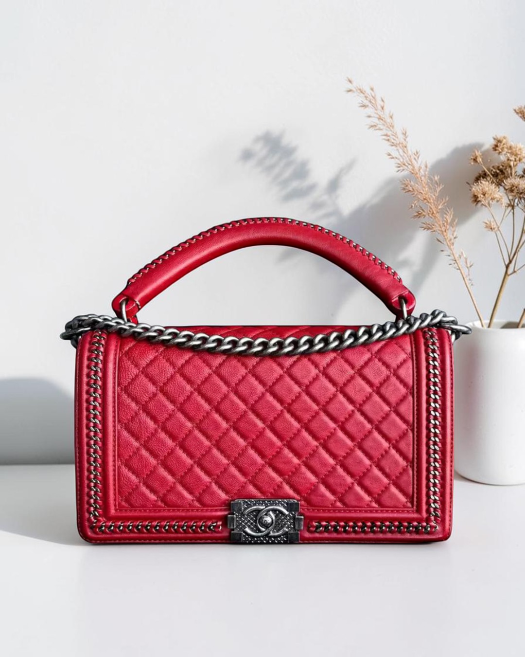 Luxury Evermore red quilted calfskin Chanel Boy bag with top handle and palladium silver hardware