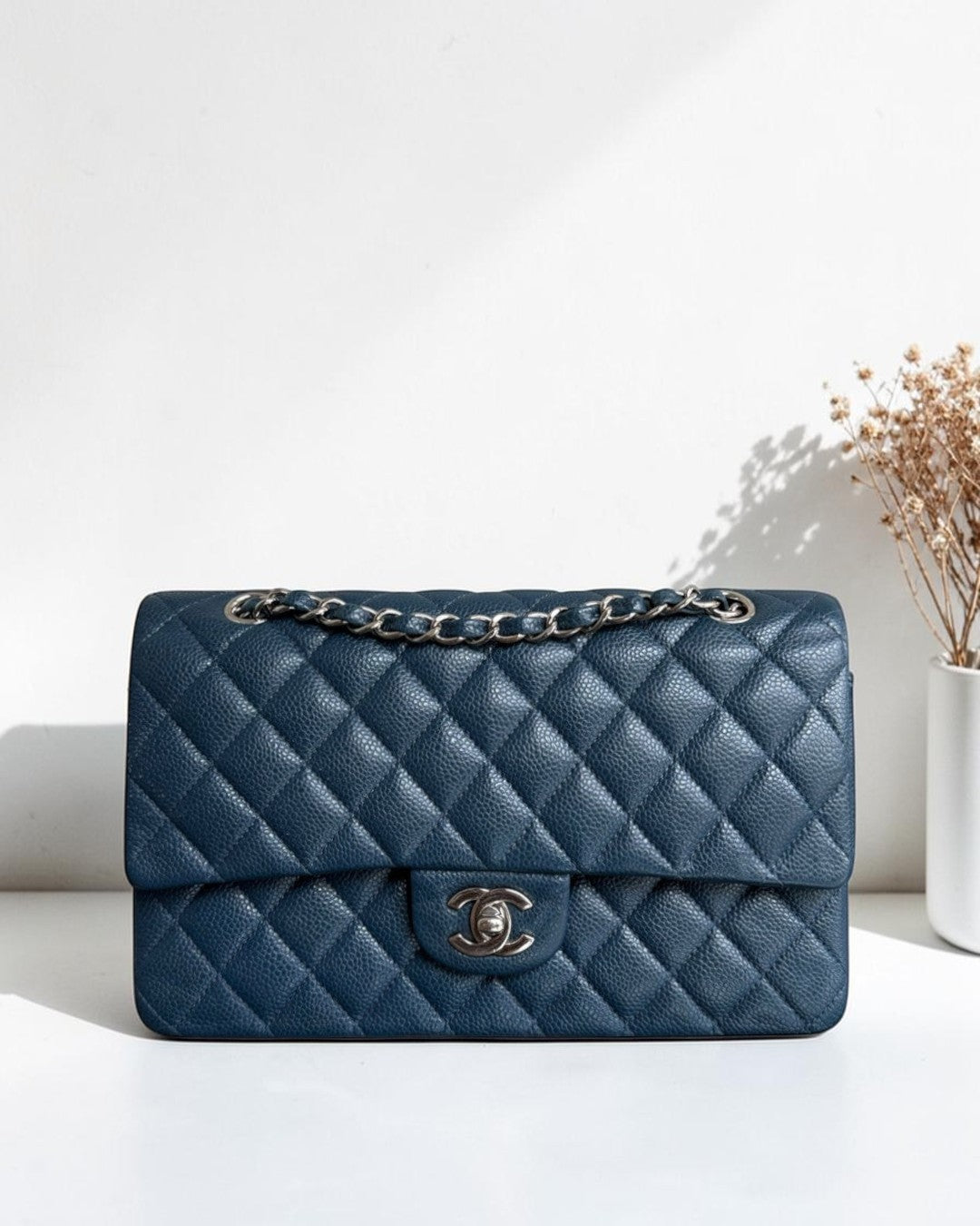 Luxury Evermore blue quilted leather handbag with silver chain strap and iconic CC turn-lock closure