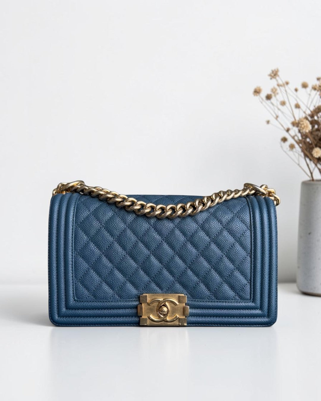Luxury Evermore Chanel Boy Medium quilted blue caviar leather handbag with gold hardware and chain strap
