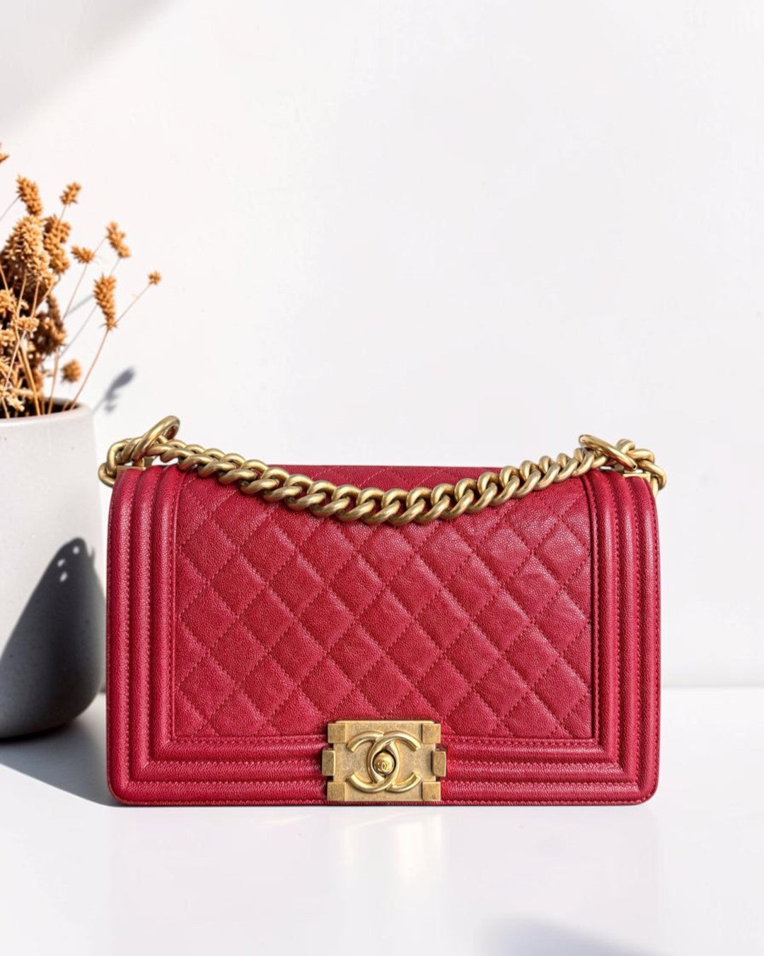 Luxury Evermore Chanel Boy medium quilted red caviar leather handbag with gold hardware and chain strap