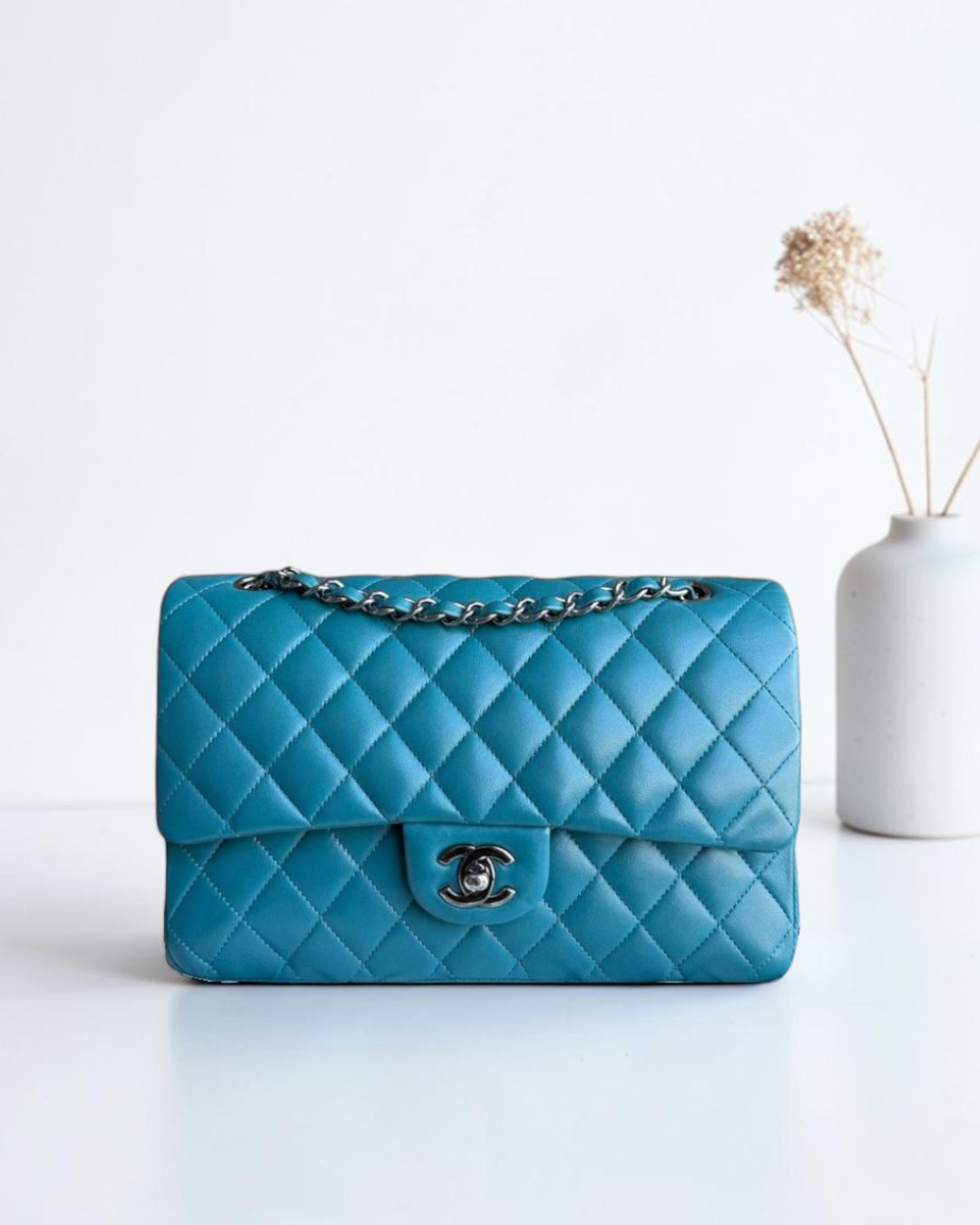 Luxury Evermore 蓝色菱格纹羊皮 Chanel Classic Flap 中号手袋，配有银色金属链条和标志性双C锁扣。