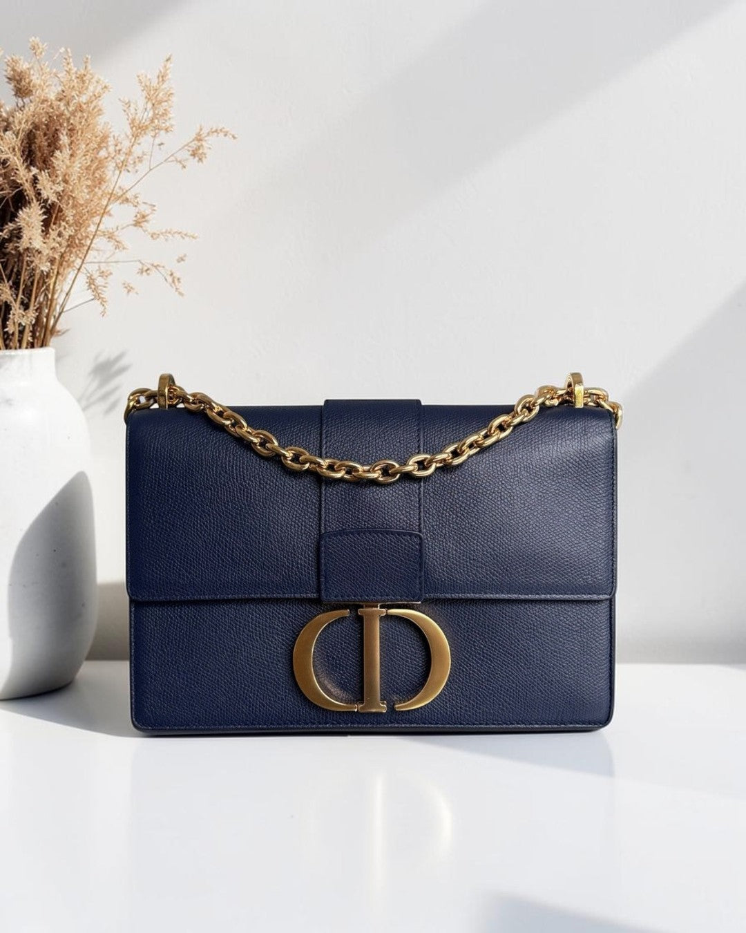 Luxury Evermore dark blue caviar leather Dior 30 Montaigne medium bag with gold hardware and chain strap.