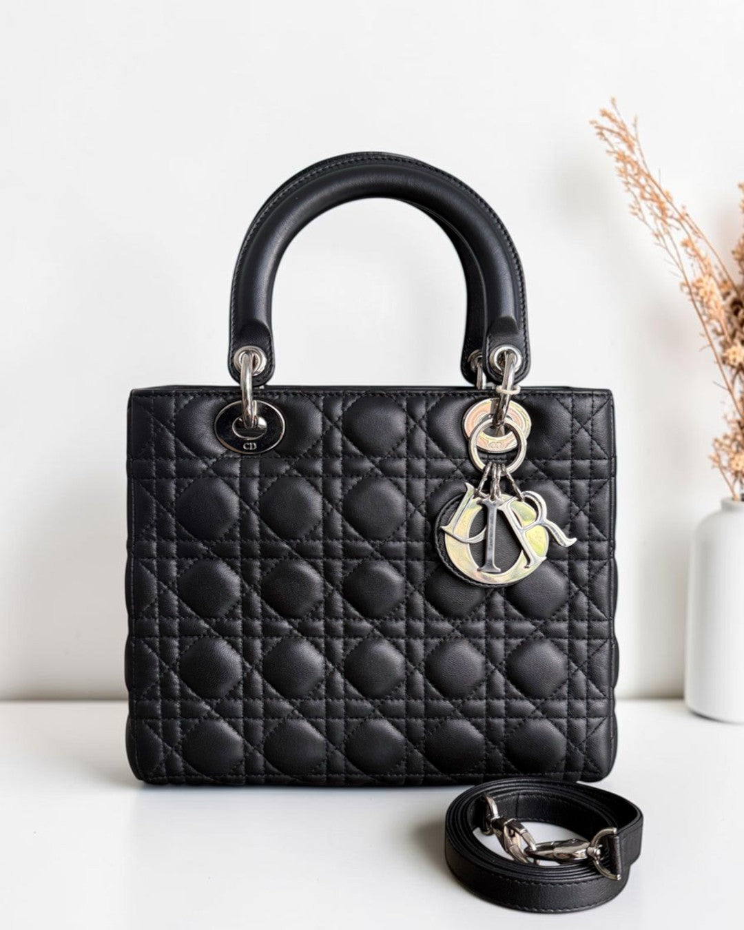 Luxury Evermore medium Dior Lady bag in black lambskin with iconic cannage stitching and silver hardware charms.