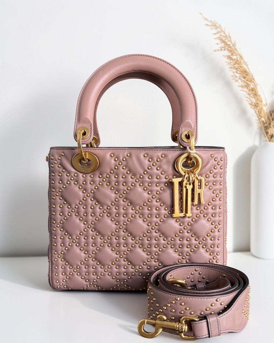Luxury Evermore Dior Lady Medium Flap bag in blush pink leather with gold studded cannage pattern and gold hardware.