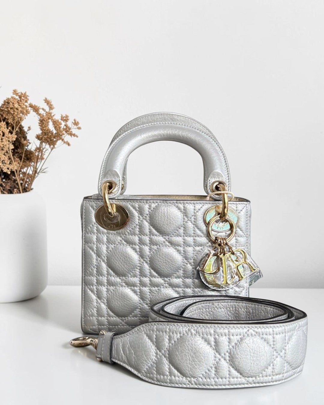 Luxury Evermore mini silver quilted leather handbag with gold-tone hardware and detachable shoulder strap