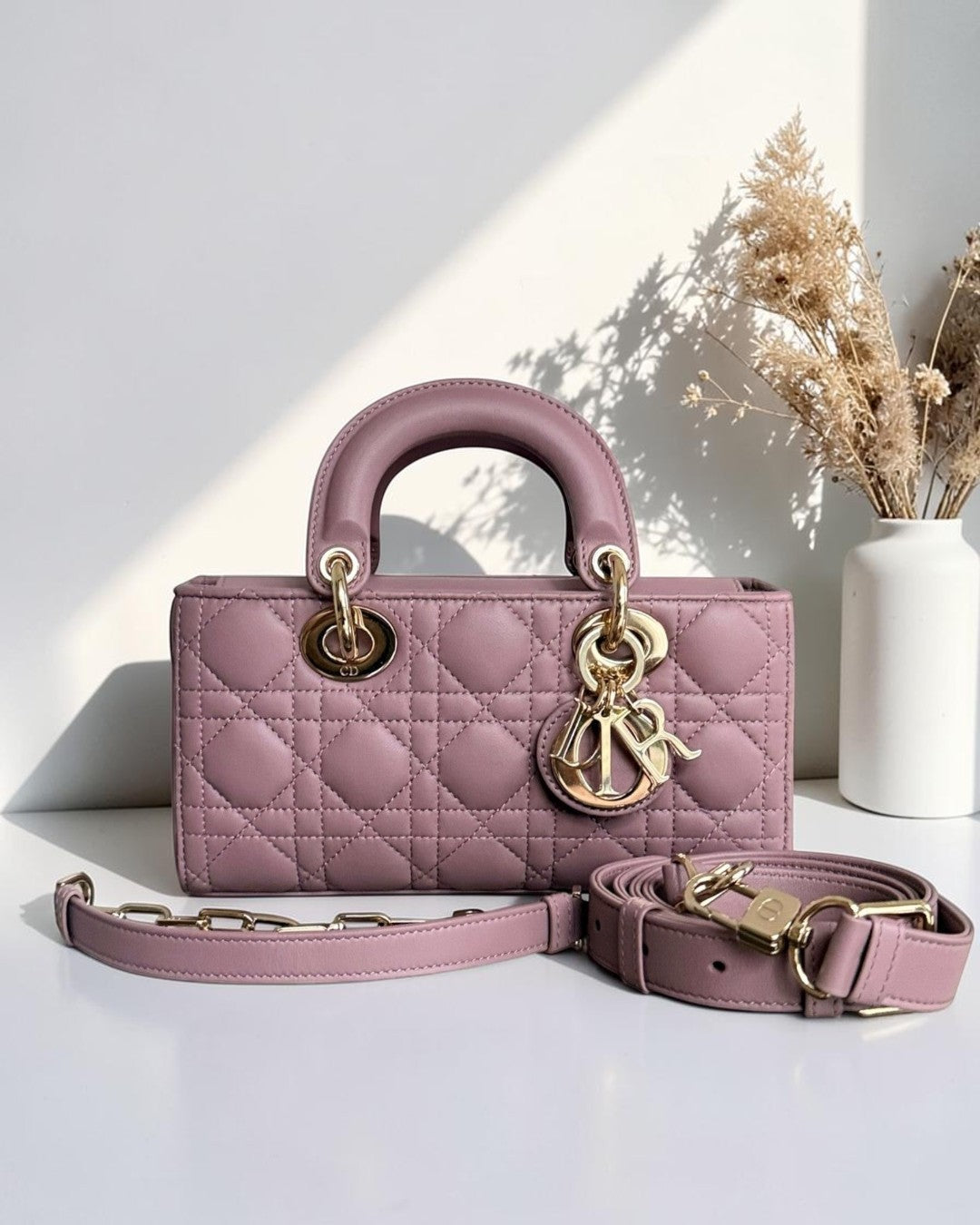 Luxury Evermore pink lambskin Dior D-Joy small Lady bag with cannage stitching and gold hardware.