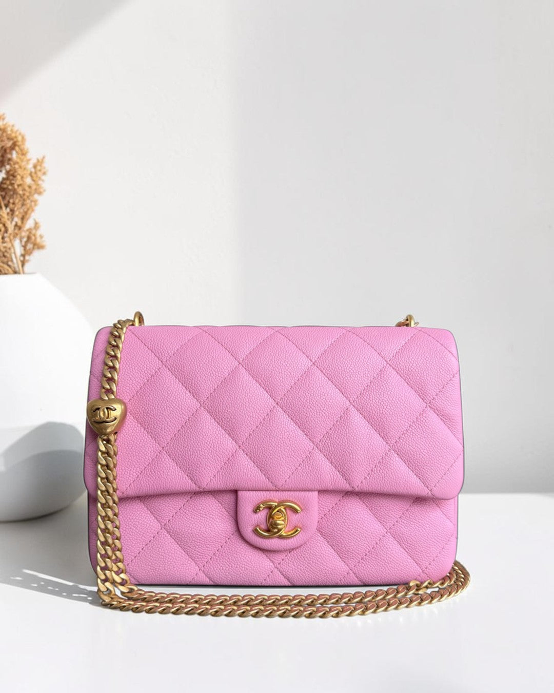 Luxury Evermore medium pink quilted caviar leather Chanel flap bag with gold-tone chain strap and heart charm