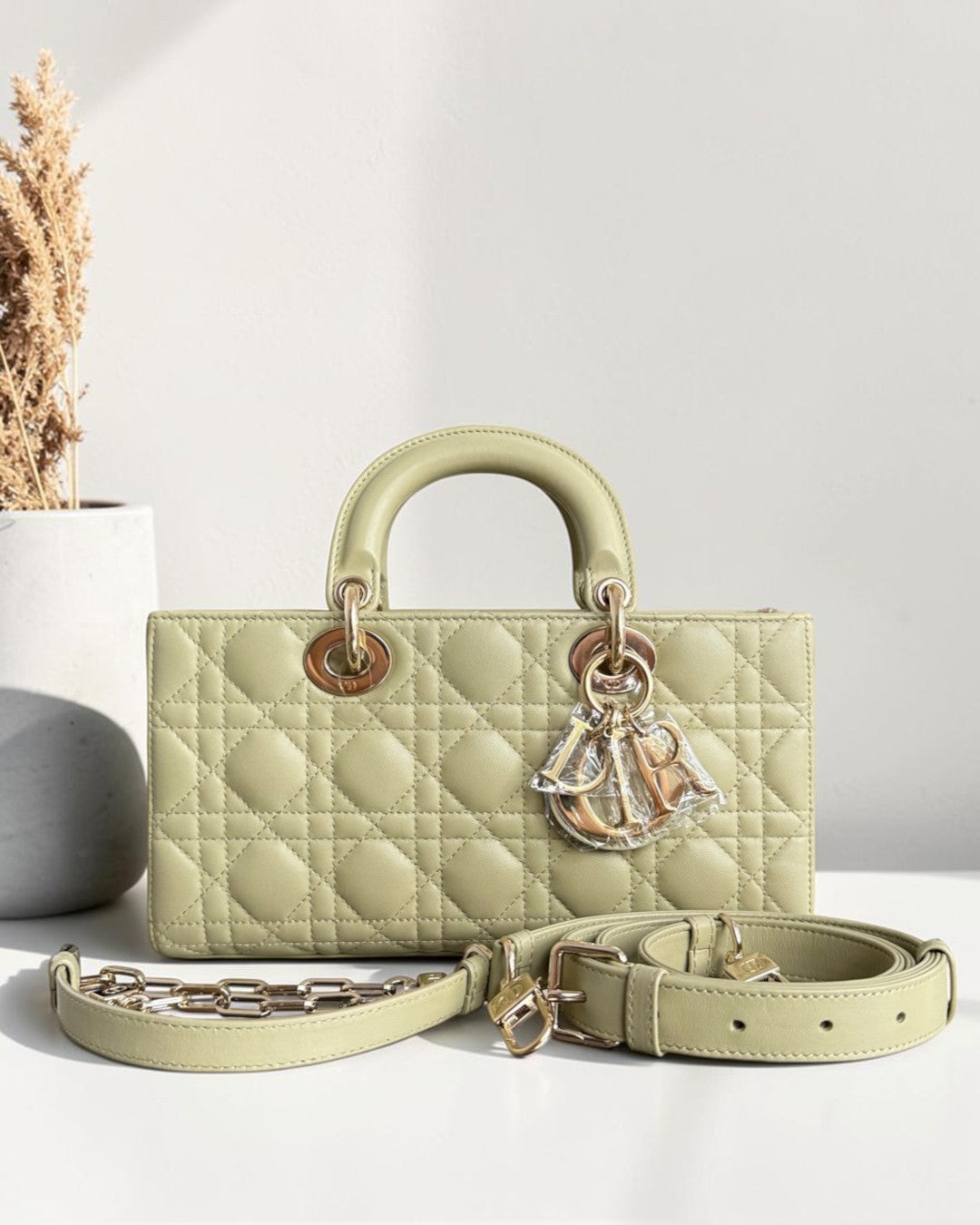 Luxury Evermore medium sage green quilted leather handbag with gold hardware and dangling logo charms