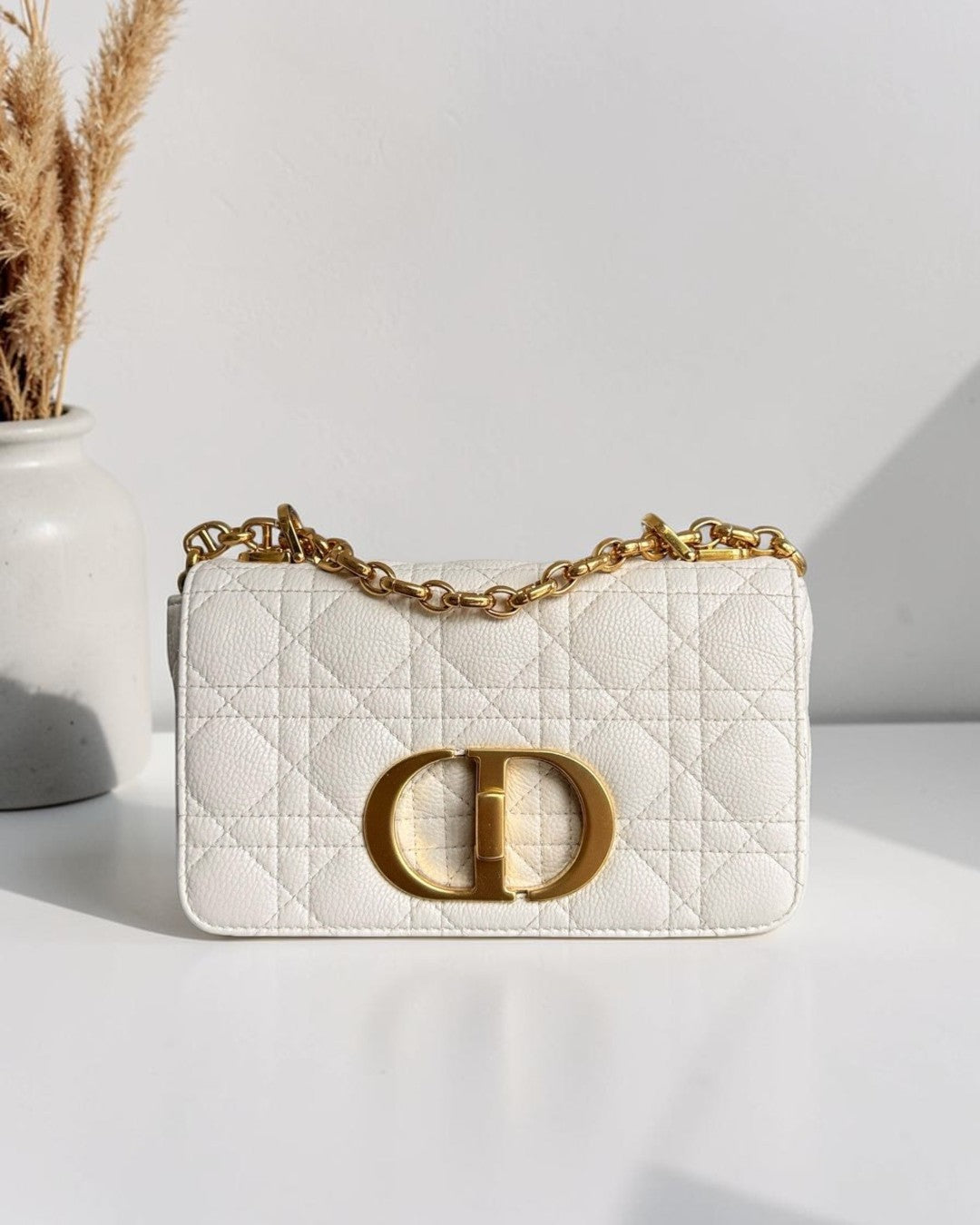 Luxury Evermore white grained calfskin Dior Caro small bag with gold hardware and CD clasp.